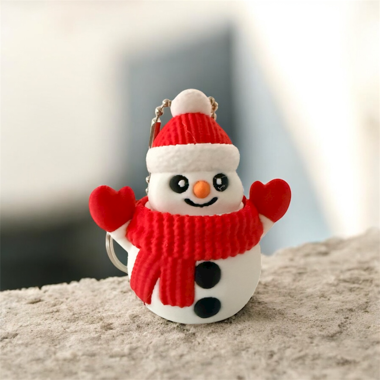 Red and white snowman fidget toy keychain with festive design