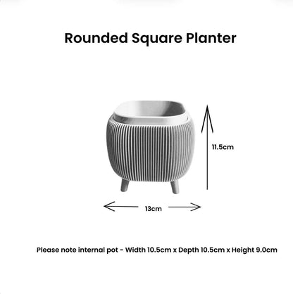 Bright yellow retro rounded square planter with ribbed texture and raised feet for indoor plants