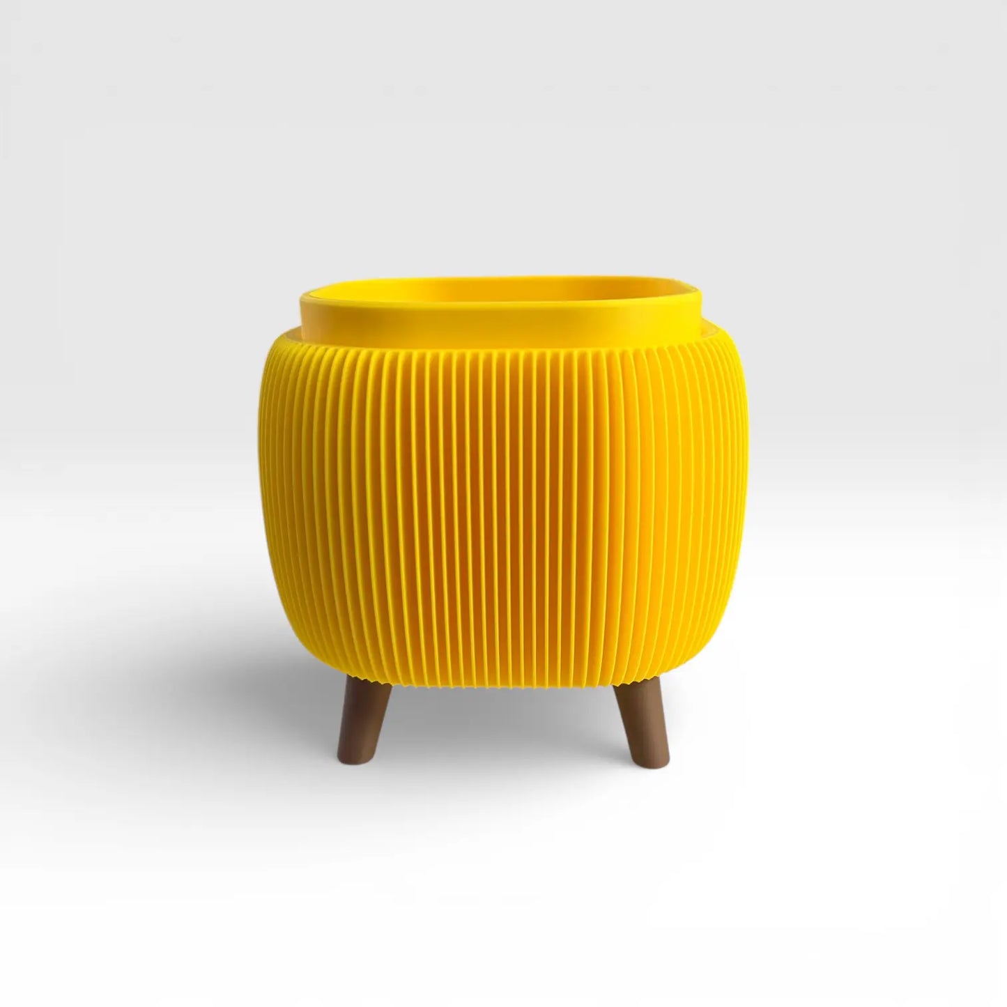 Bright yellow retro rounded square planter with ribbed texture and drainage liner insert for indoor plants