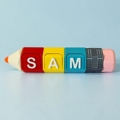 A fidget toy-like pencil shaped with four colored blocks spelling 'SAM' in white letters, set against a light blue background.