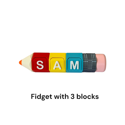 A toy fidget shaped like a pencil with colorful letter blocks spelling 'SAM' on the writing arm, plus a pink eraser and black ferrule, shown on a white background with the text 'Fidget with 3 blocks' below.