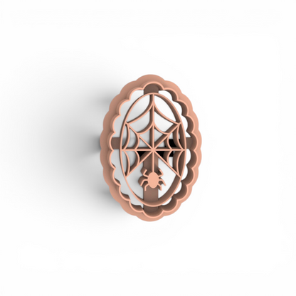 Aplastic clay cutter with a spiderweb and spider design, shown from a top-down perspective on a white background.