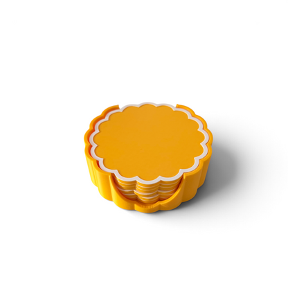 A set of sunflower yellow scalloped edge coasters edged in white with matching holder